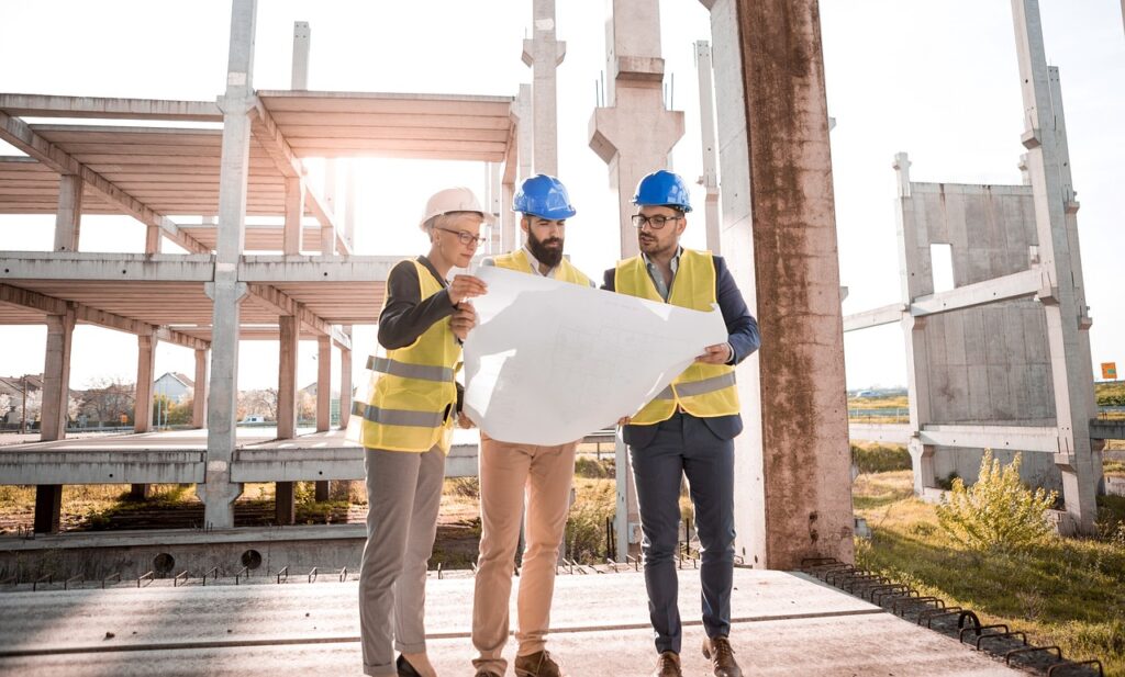 Architect and support workers on a construction site