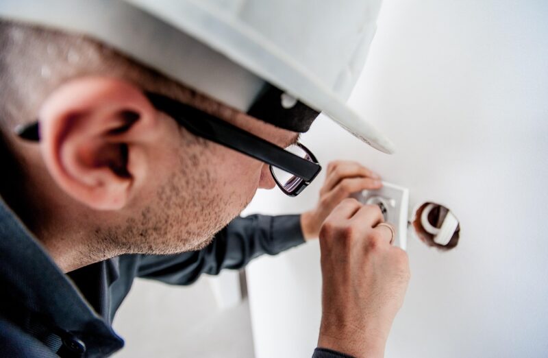 Electrician wiring a plug