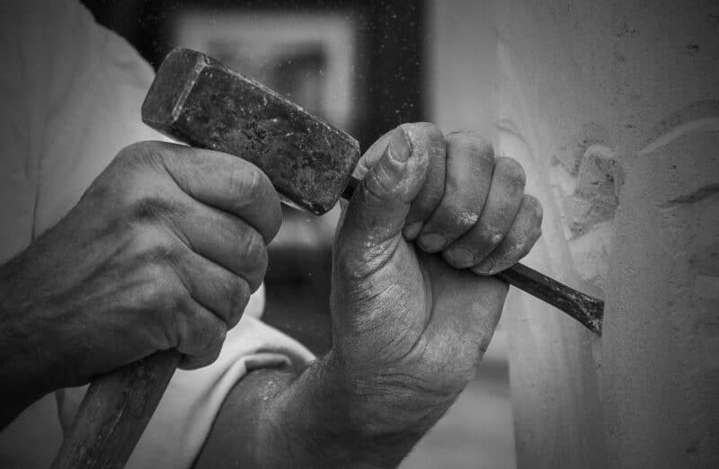 Stone Mason chiseling a wall